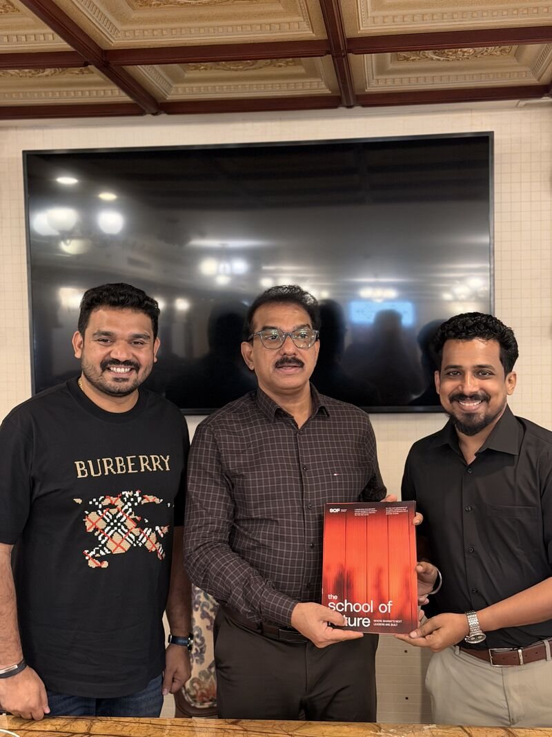 Akshay and a colleague presenting the SOF prospectus to a guest