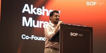 Akshay speaking at the podium at the SOF inauguration